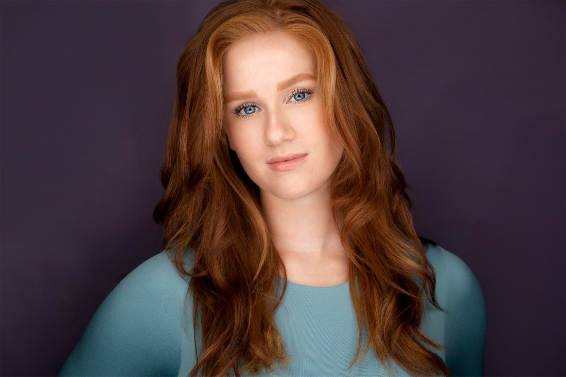 Actor headshot against a plum backdrop