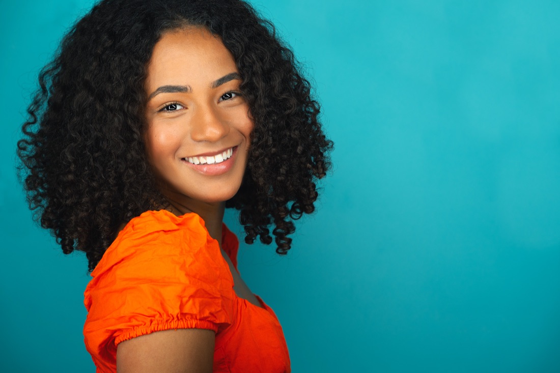 Actor headshot against a teal backdrop