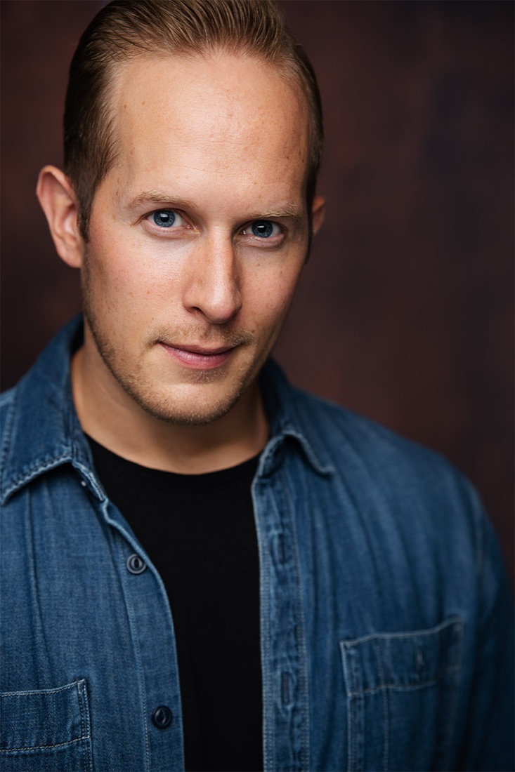 Actor headshot against a dark brown backdrop