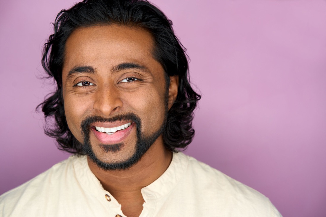 Actor headshot against a lilac backdrop